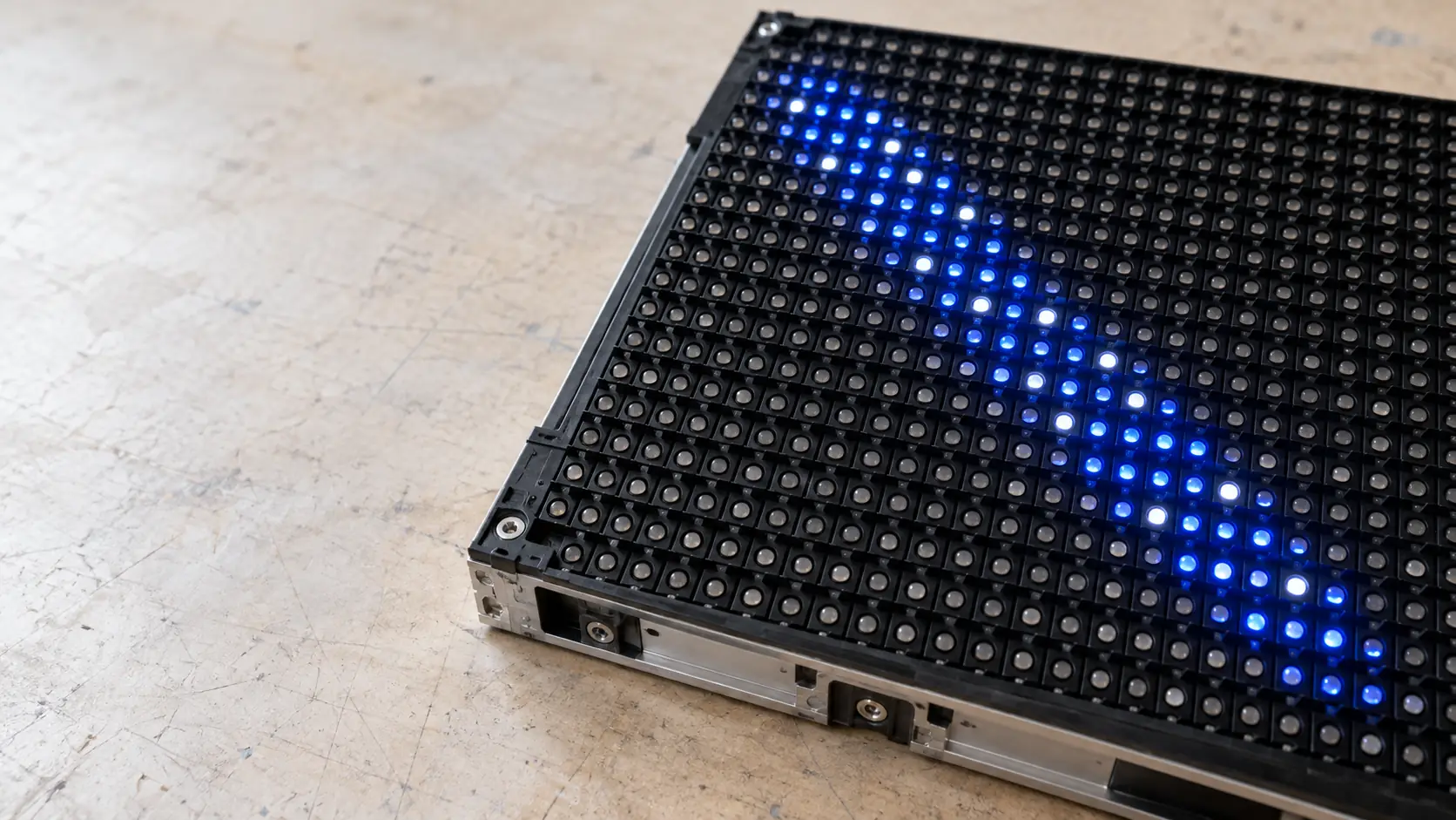 Close-up of an LED display module with a band of blue diodes lit